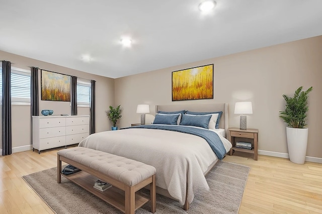 bedroom with light wood-style flooring and baseboards