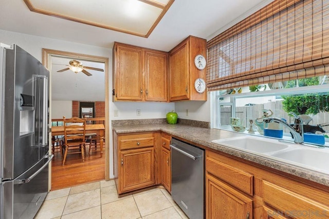 kitchen with sink, stainless steel appliances, ceiling fan, and light tile patterned flooring