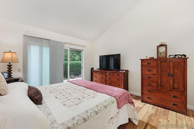 bedroom featuring vaulted ceiling, access to outside, and light hardwood / wood-style floors