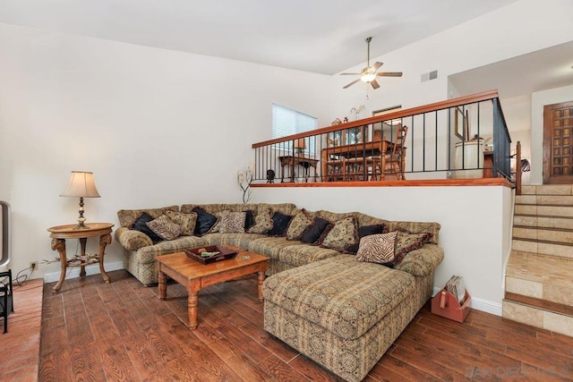 living room featuring lofted ceiling, dark hardwood / wood-style floors, and ceiling fan