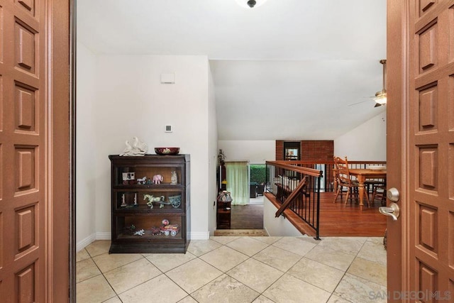 tiled foyer featuring ceiling fan