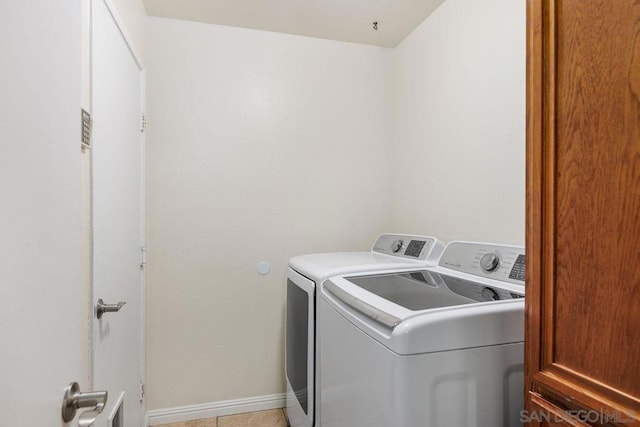 clothes washing area featuring light tile patterned flooring and independent washer and dryer