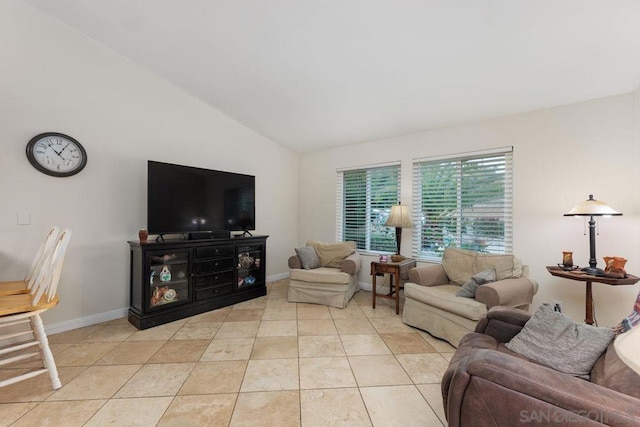 living room featuring vaulted ceiling and light tile patterned flooring