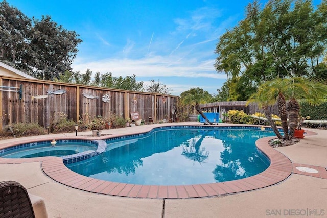 view of swimming pool featuring an in ground hot tub