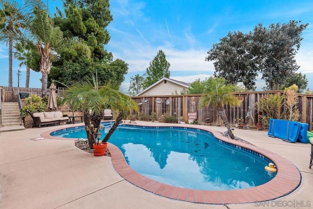 view of swimming pool with a patio area