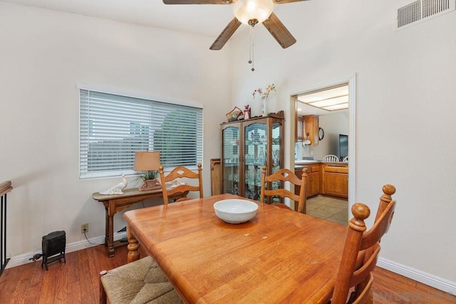 dining space with ceiling fan and light hardwood / wood-style floors