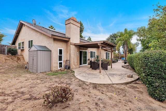 back of house with a patio and a storage unit