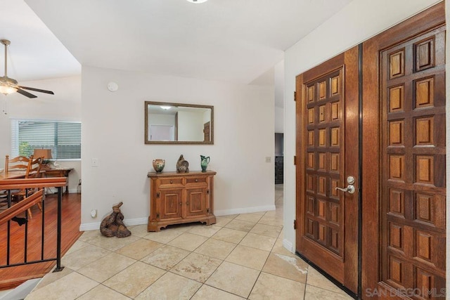 tiled foyer entrance with ceiling fan