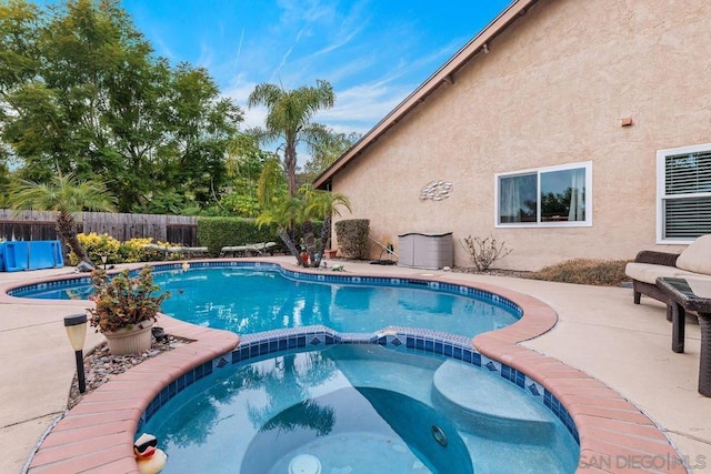 view of pool with an in ground hot tub