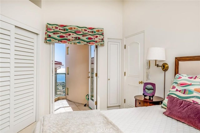 tiled bedroom with a closet