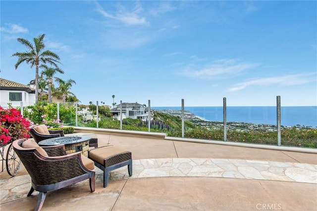 view of patio featuring a fire pit and a water view