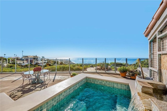 view of pool featuring a patio and a water view