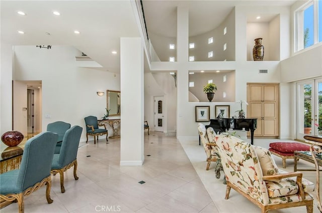 interior space featuring light tile patterned floors and a high ceiling