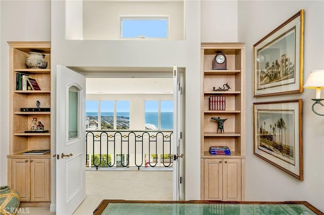 doorway featuring built in shelves and a water view