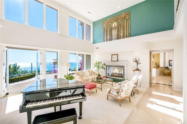 interior space featuring a high ceiling and light tile patterned flooring