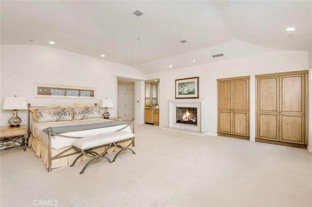 carpeted bedroom featuring vaulted ceiling