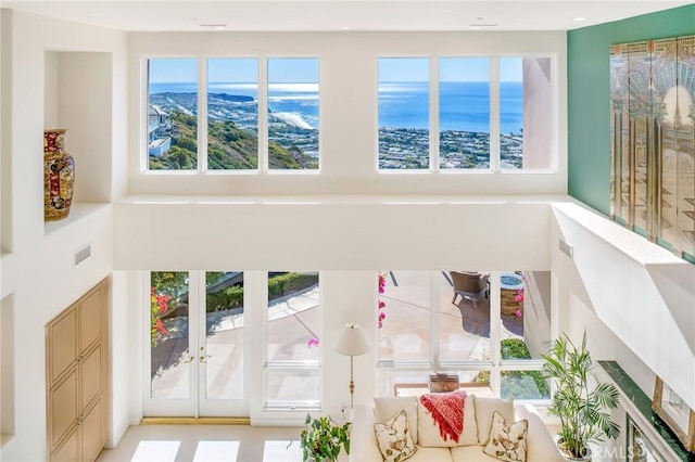 interior details featuring french doors and a water view