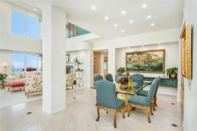 tiled dining space featuring a high ceiling