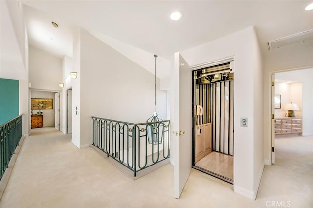 hall with lofted ceiling and carpet flooring