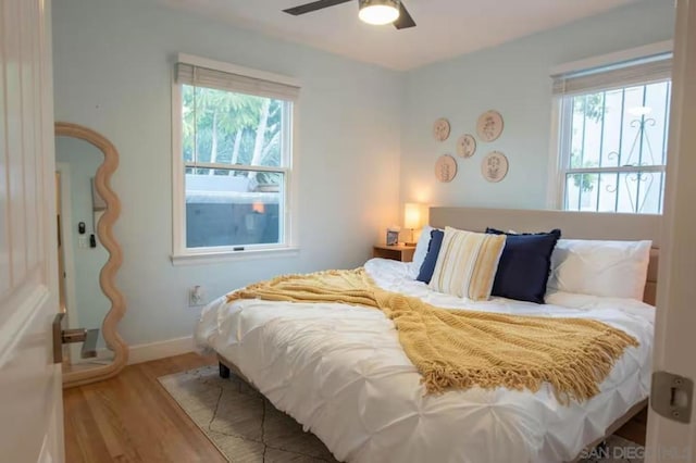 bedroom with hardwood / wood-style floors and ceiling fan