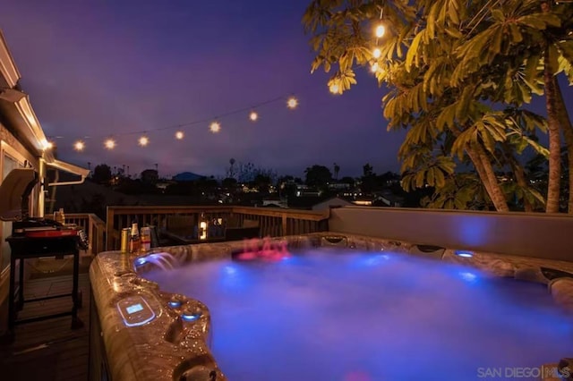 view of swimming pool with an outdoor hot tub