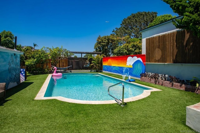 view of pool with a yard