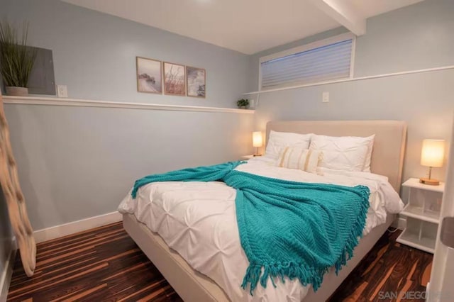 bedroom with dark wood-type flooring and beamed ceiling