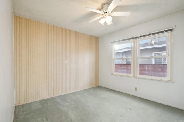 unfurnished room with carpet floors and ceiling fan