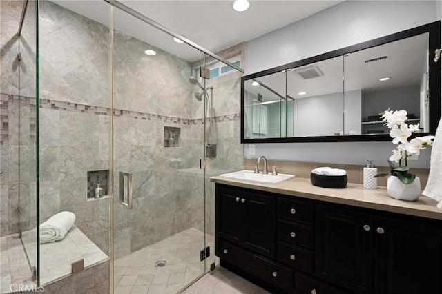 bathroom featuring vanity and an enclosed shower