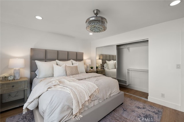 bedroom with dark wood-type flooring and a closet