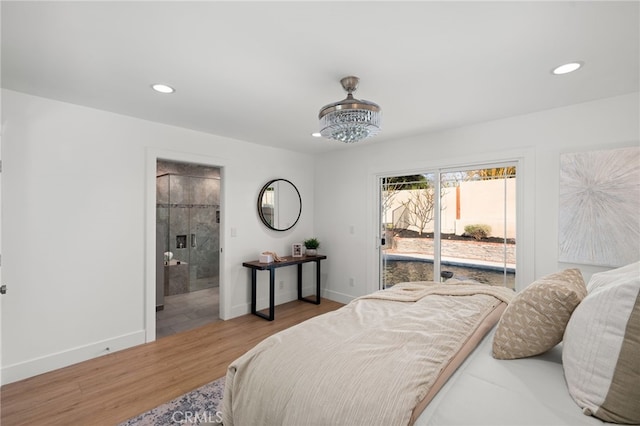 bedroom with wood-type flooring, access to exterior, and ensuite bathroom