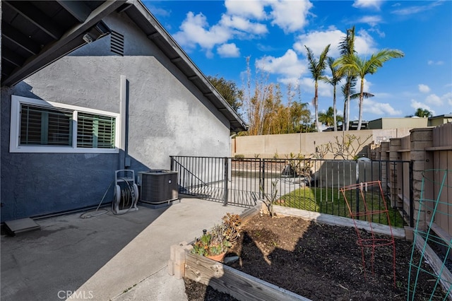 view of side of property featuring central AC and a patio area