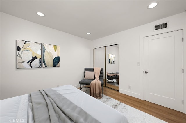 bedroom featuring wood-type flooring and a closet