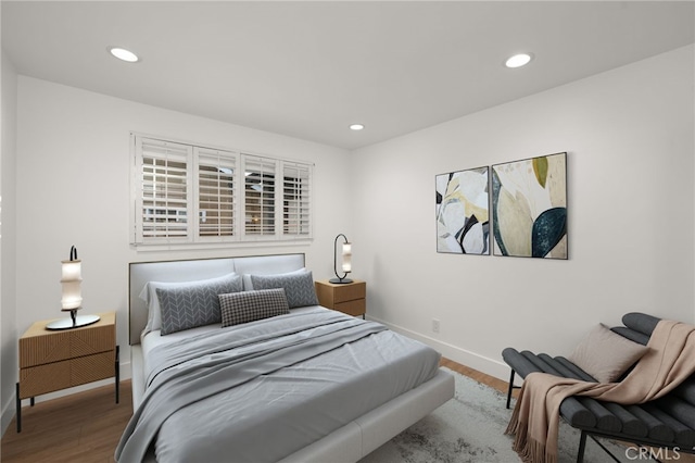 bedroom with hardwood / wood-style floors