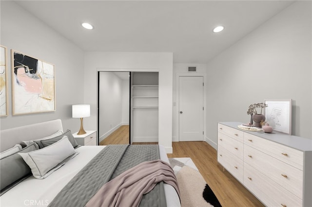 bedroom featuring a closet and light wood-type flooring