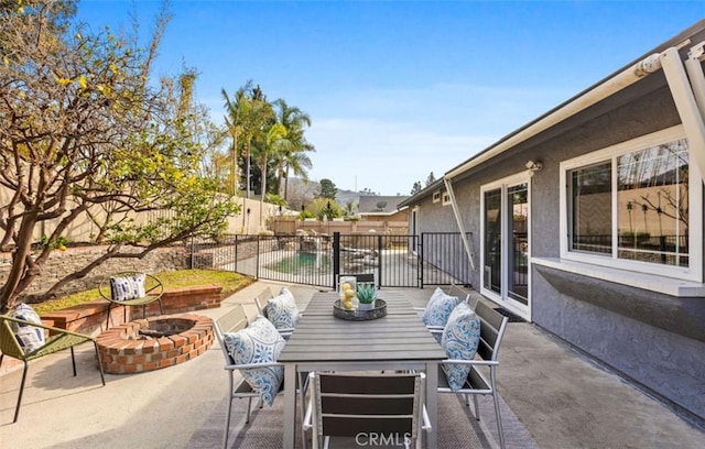 view of patio / terrace featuring an outdoor fire pit