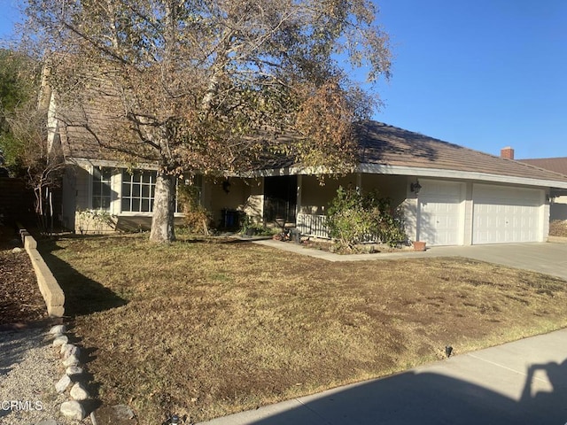 view of front facade with a garage and a front yard