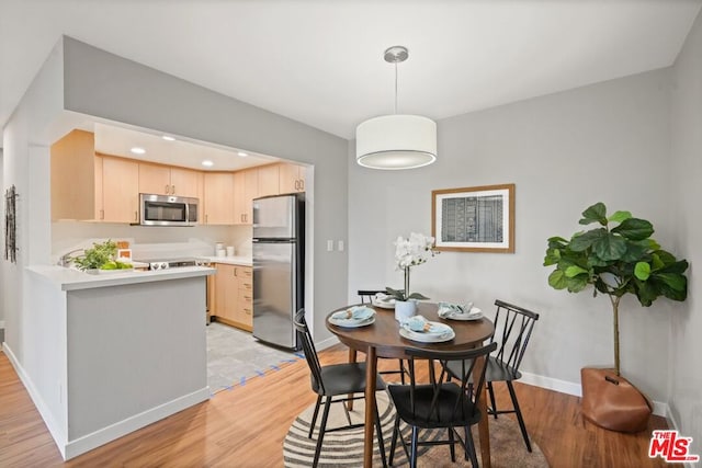 dining area with light wood-type flooring