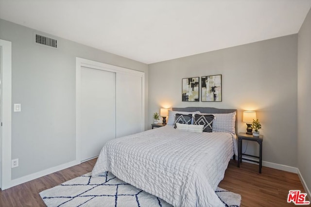 bedroom with hardwood / wood-style flooring and a closet