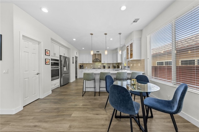 dining space featuring sink and light wood-type flooring