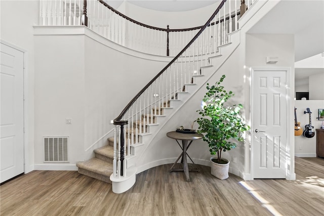 interior space featuring a high ceiling and hardwood / wood-style floors