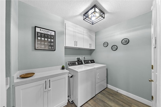 washroom with dark hardwood / wood-style flooring, washing machine and dryer, and a textured ceiling