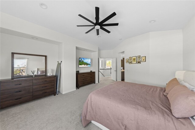 bedroom featuring light carpet, lofted ceiling, and ceiling fan