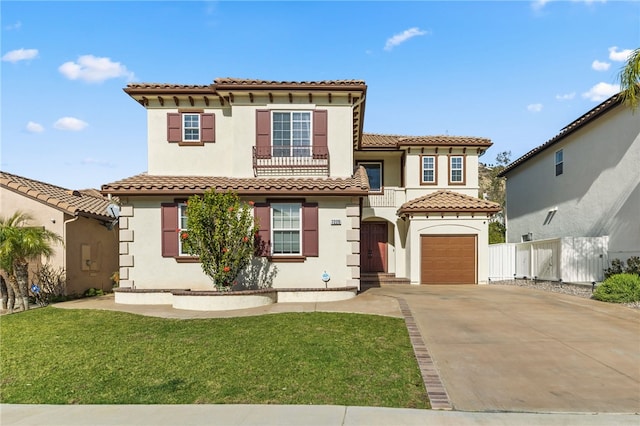 mediterranean / spanish house with a garage and a front lawn