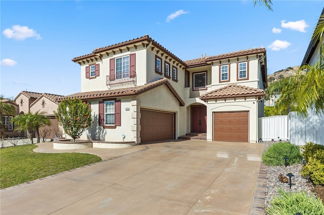 mediterranean / spanish home with a garage