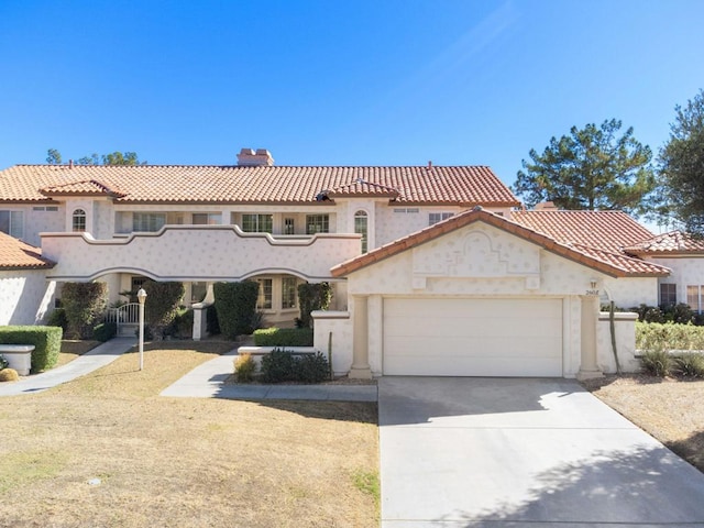 mediterranean / spanish-style home with a garage