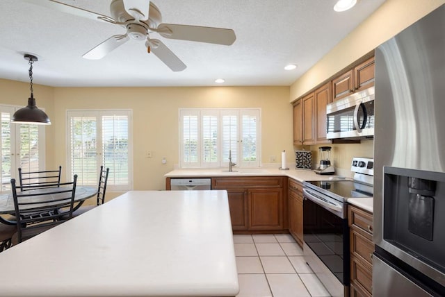 kitchen featuring light tile patterned flooring, appliances with stainless steel finishes, sink, and a wealth of natural light