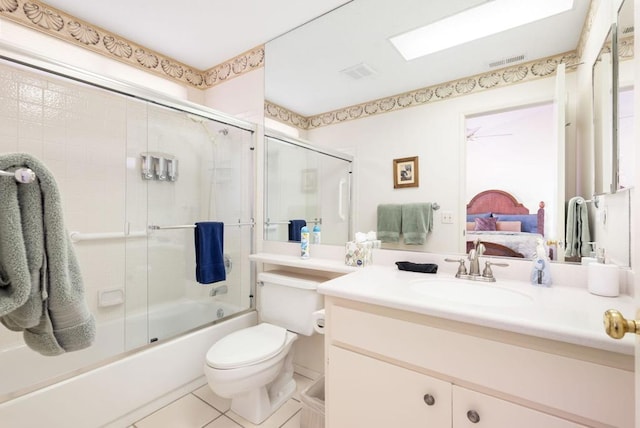 full bathroom featuring tile patterned flooring, vanity, enclosed tub / shower combo, and toilet