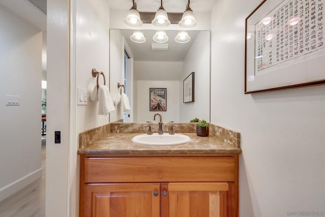 bathroom featuring vanity and hardwood / wood-style floors