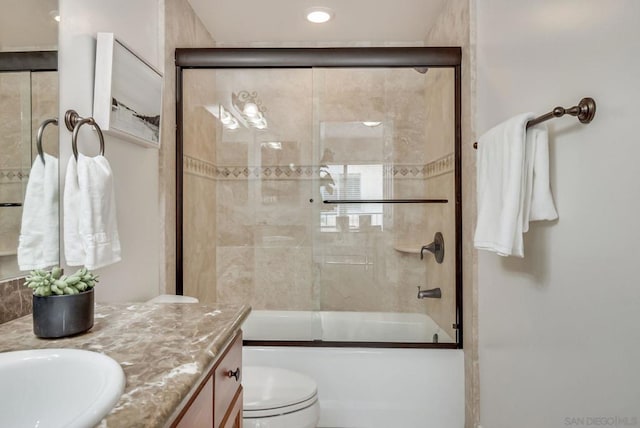 full bathroom with vanity, toilet, and combined bath / shower with glass door